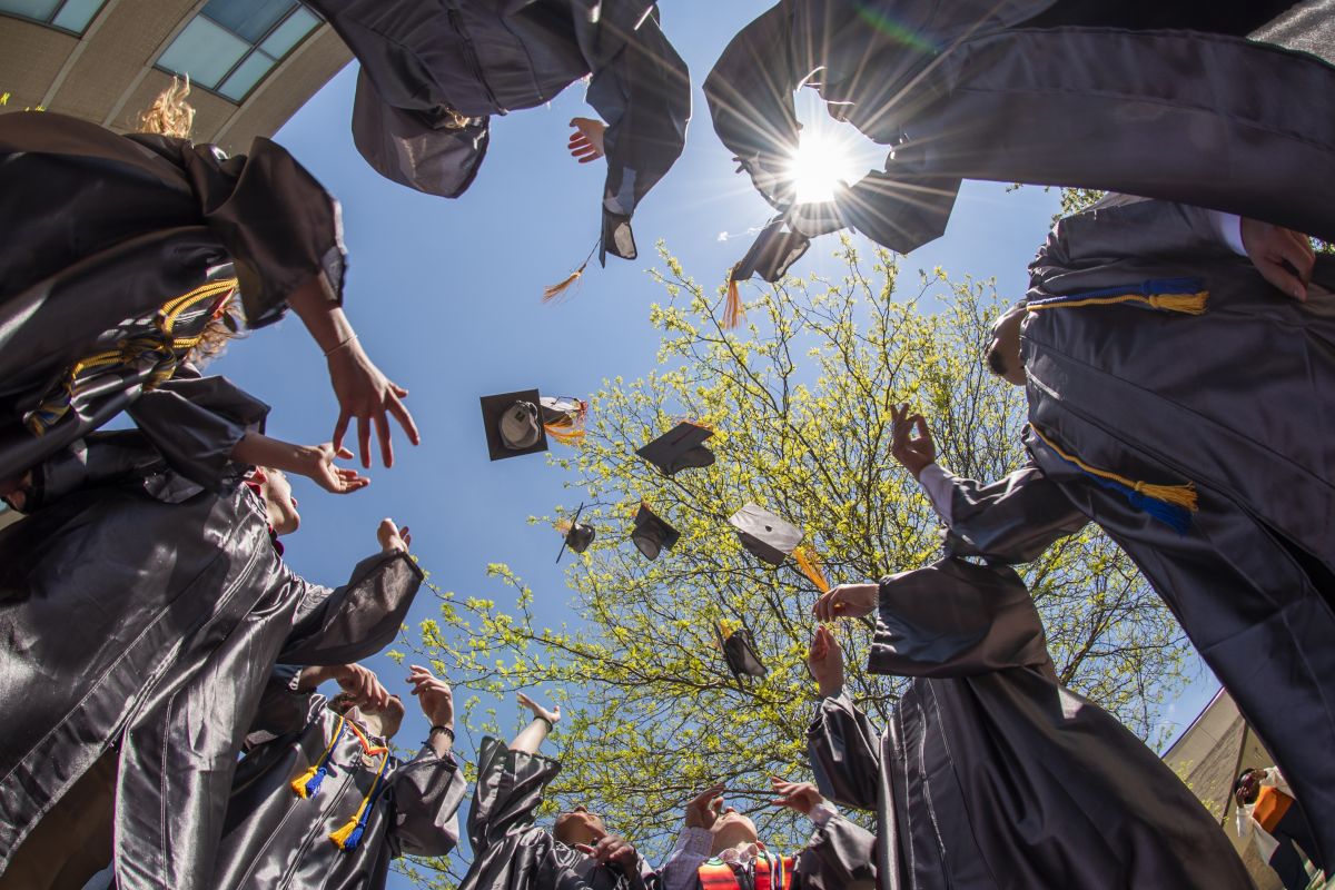 Graduates tossing hats