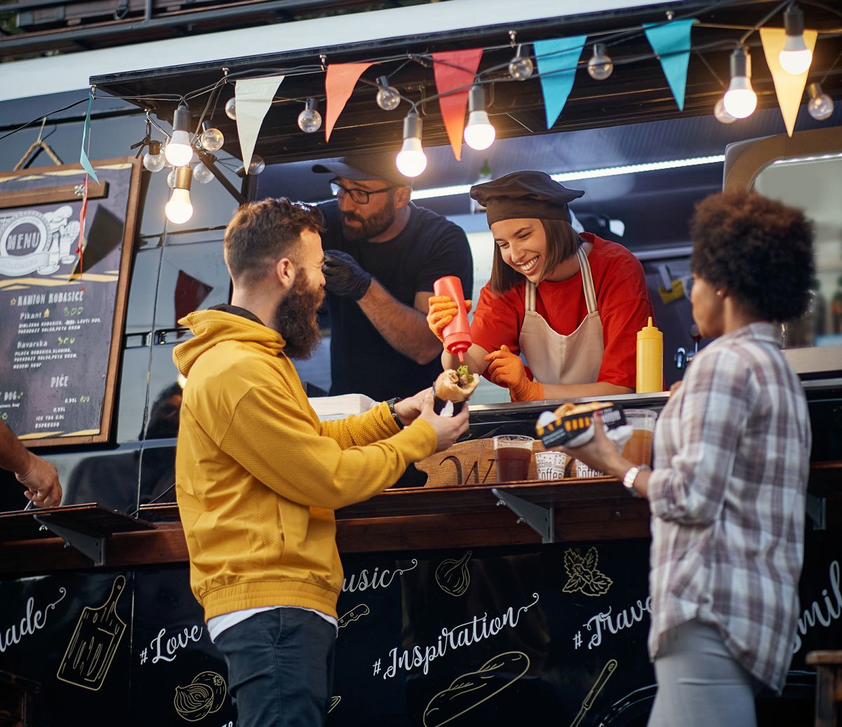 Two customers being served at a food truck