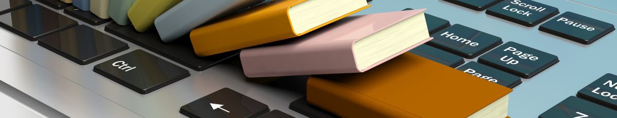 Books cascading over a laptop