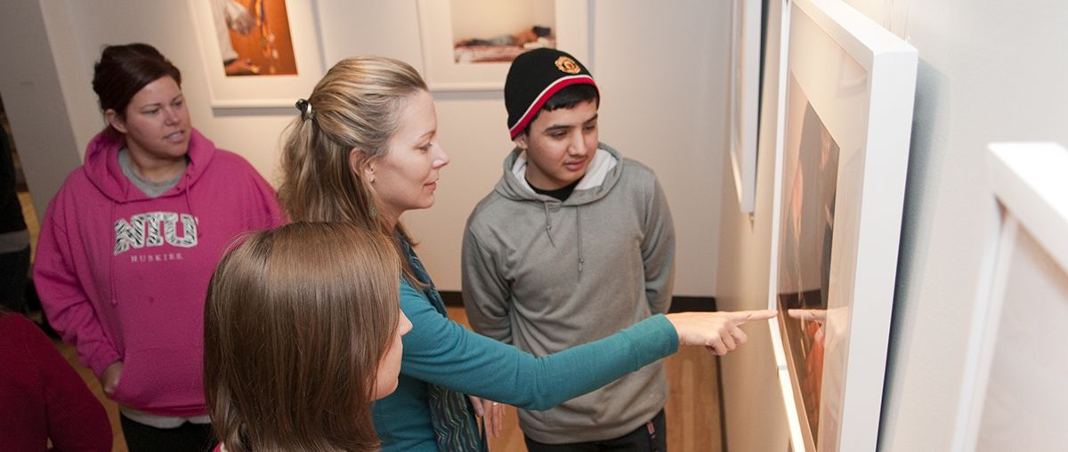 Art faculty Heather Weber shows students artwork in the Arrowhead Room. 