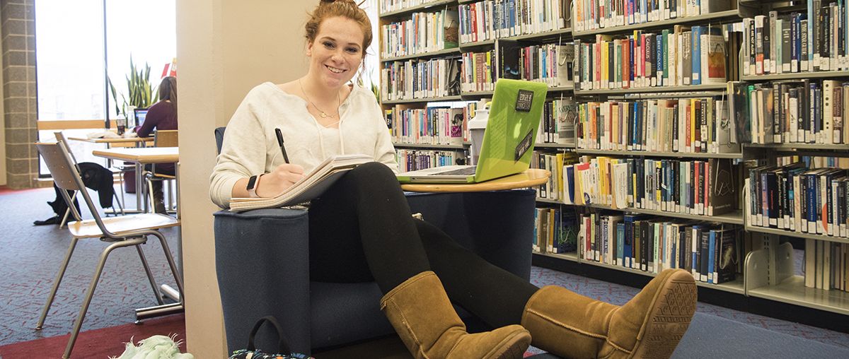 female student sitting in library L