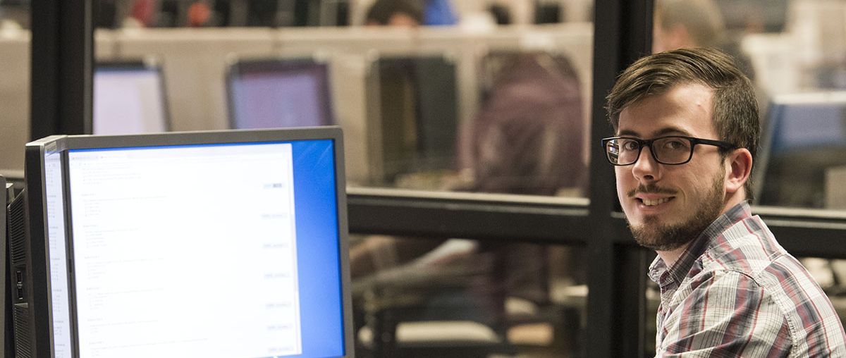 Male Student working on a desktop computer