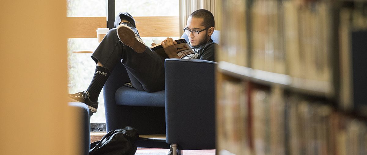 Student reading in library L