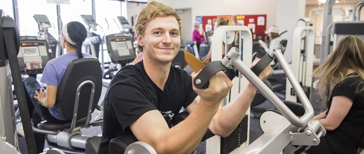 student using fitness equipment