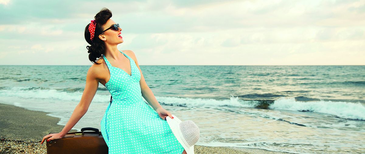 Girl from 50's on beach in blue dress red shoes L