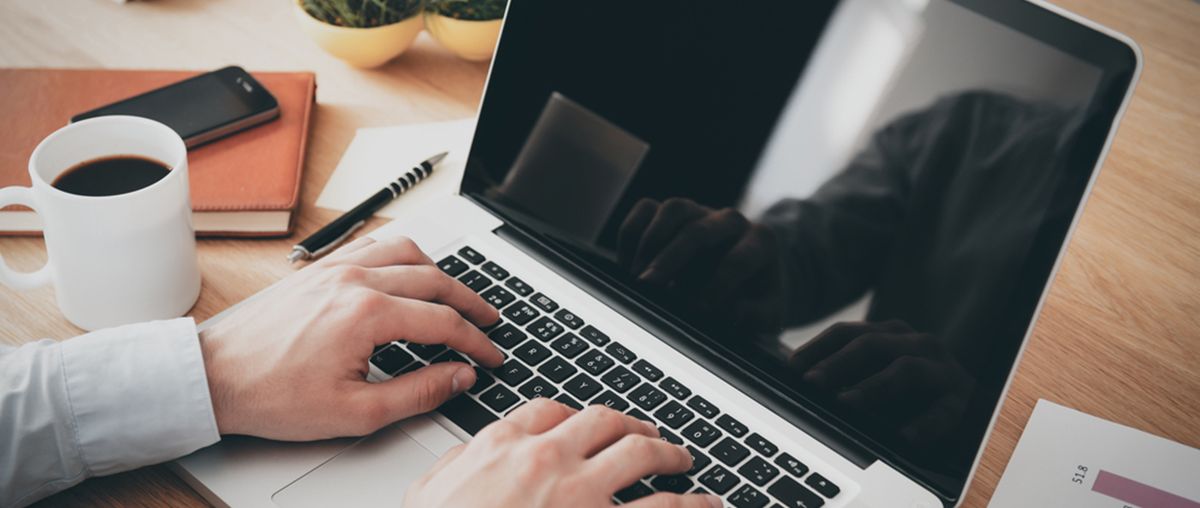 person on laptop with coffee L