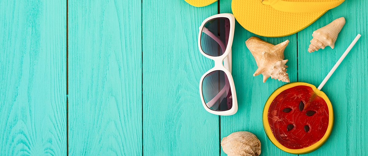 Summer scene with flip flops, sunglasses and shells