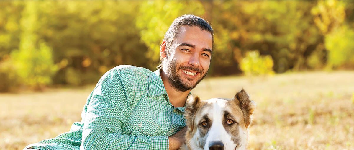 photo of man with dog