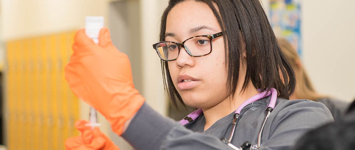 Female Nursing Student using syringe