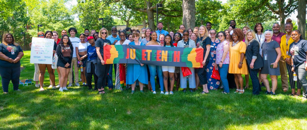 students holding a Juneteenth banner