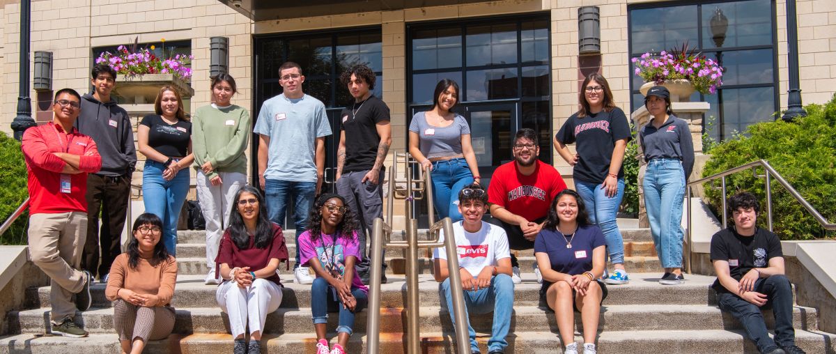 Latinx Resource Center (LRC) students in front of Aurora Campus building