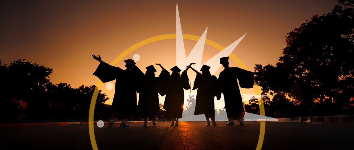 silhouettes of graduates throwing caps in the air in the sunset