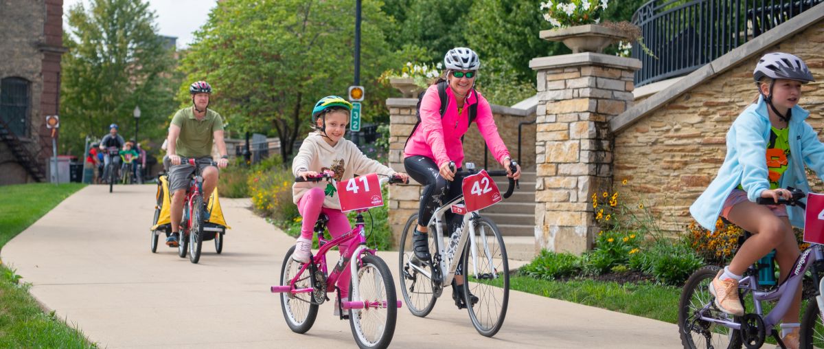 Bike riders on the path near Aurora Downtown campus