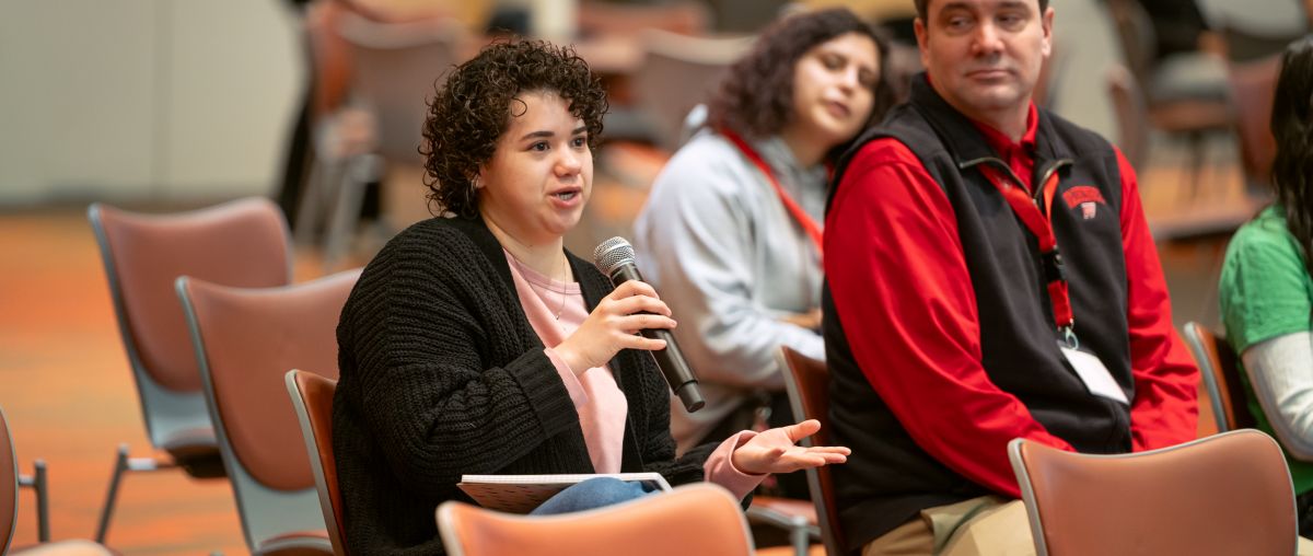 Audience member speaking into microphone at 2025 WIOA Youth Conference