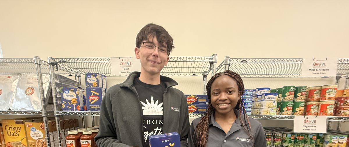 Waubonsee student workers John Metych (Left) and Germaine Mwizera (Right) stock the shelves ahead of the fall semester.