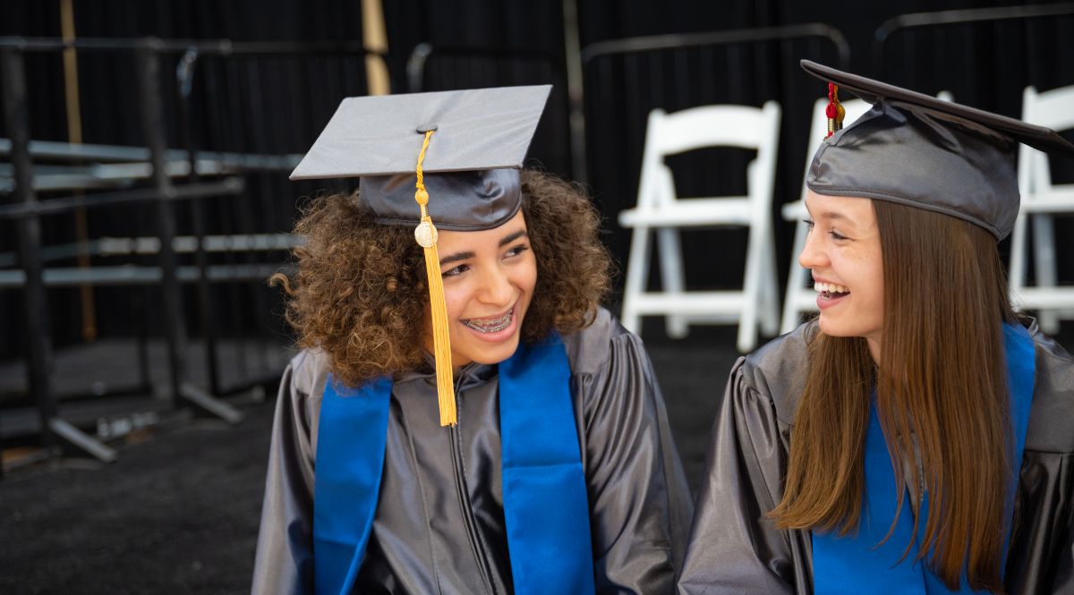 Two female Quickpath Graduates sitting and smiling