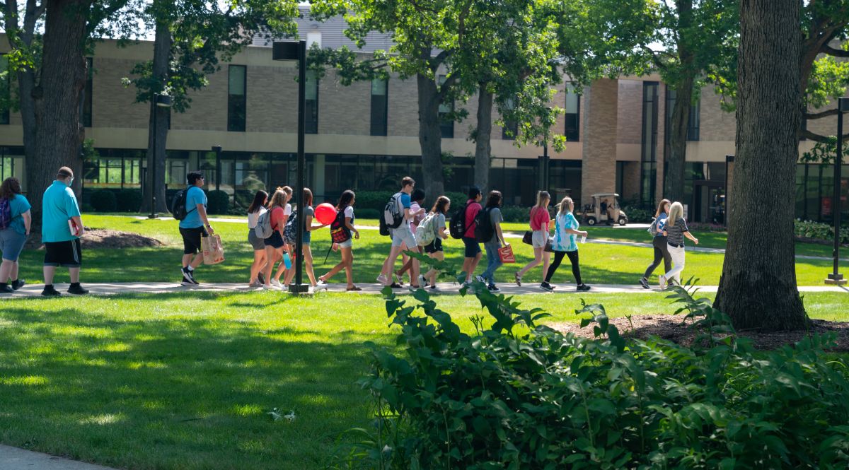 Students walking paths on campus in summer