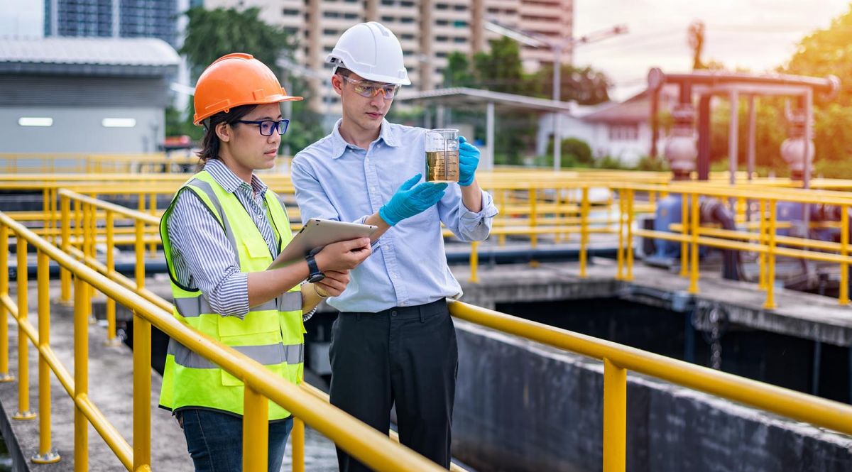 Wastewater workers examining water sample