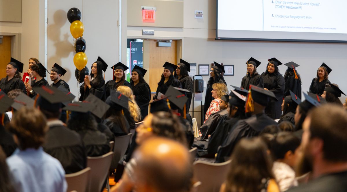Several graduates lining up to be announced at the Adult Education Commencement Ceremony
