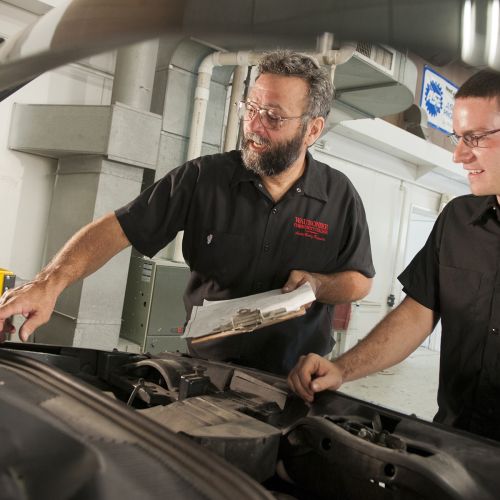 Auto Body Faculty reviewing checklist with student