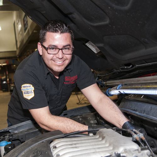 Auto Tech student working under the hood of car