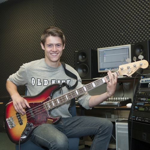 Student Practicing Guitar in Studio