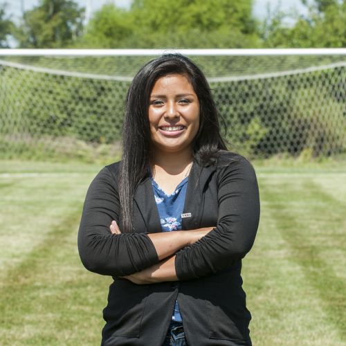 Woman standing infront of soccer goal summer S