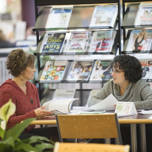 students talking in the library