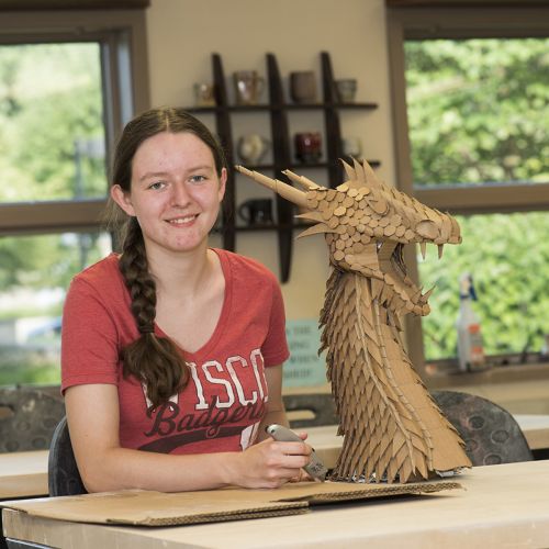 Student with Dragon Sculpture