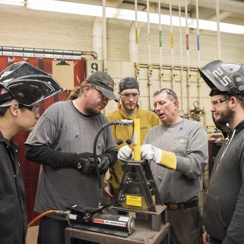 Faculty and students working in Welding Classroom