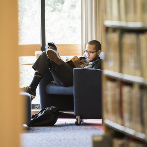 Student reading in library S