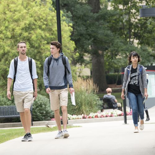 Students walking outside summer s