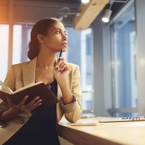 Woman Thinking Computer Book