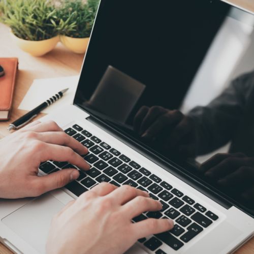 person on laptop with coffee L