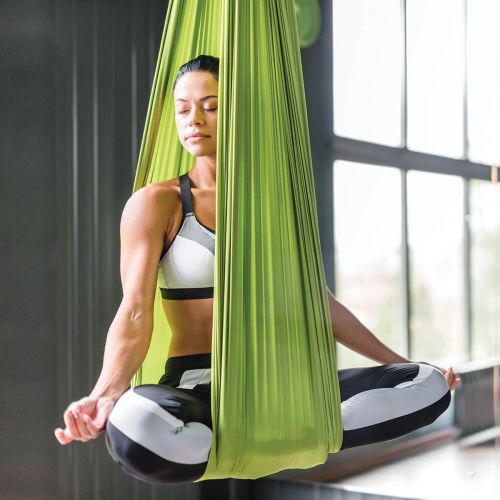 Photo of woman sitting in aerial yoga sling