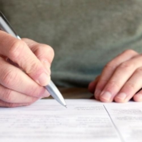 A person filling out a paper form