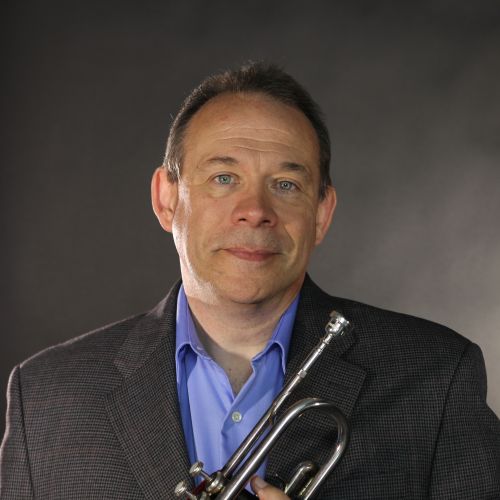 Man holds trumpet