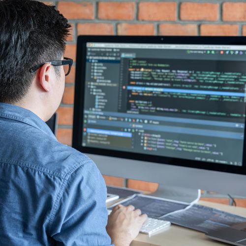 man coding on a computer