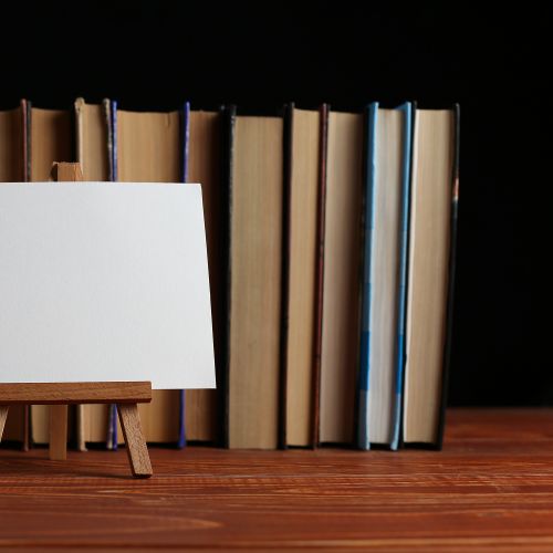 Easel in front of a row of books