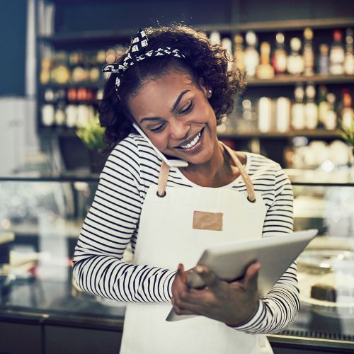Woman working on tablet in a store