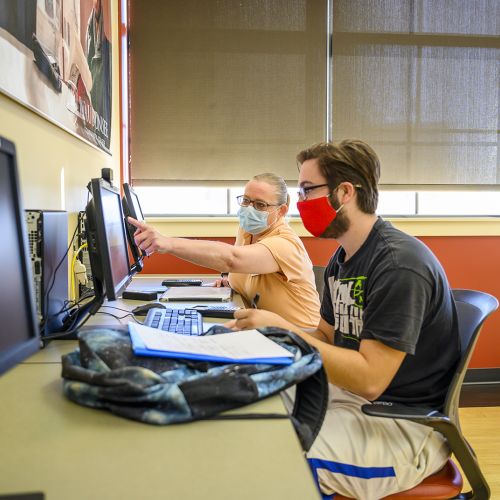 waubonsee staff helping student while wearing masks