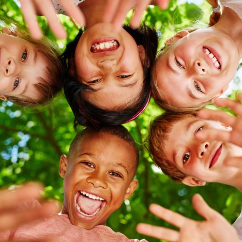 Group of kids in circle waving