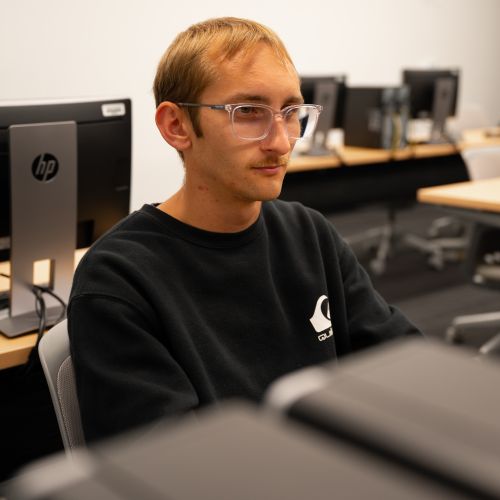 Cyber Security student working on a computer
