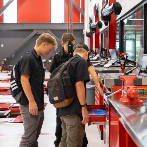 Three students checking out the Technical Education Center tool drawers