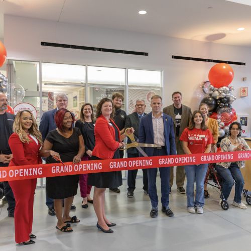 Waubonsee students, staff, and community partners cut a "Grand Opening" ribbon in front of The G.R.O.V.E. in the student center on 9-9-26