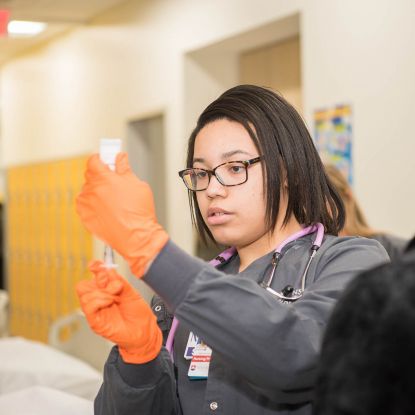 Female Nursing Student using syringe