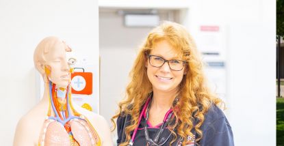 Lisa Giese, Assistant Professor of Medical Assistant and Phlebotomy, with anatomical body