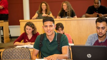 Male student in classroom with several other students