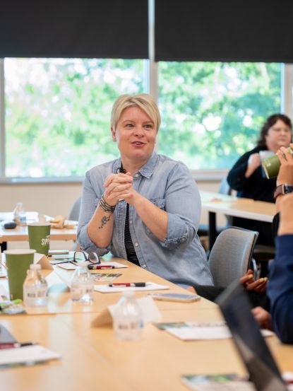 People around a conference table one person in focus