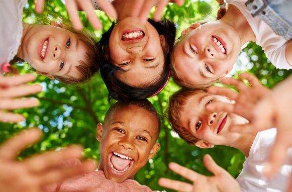 Group of kids in circle waving